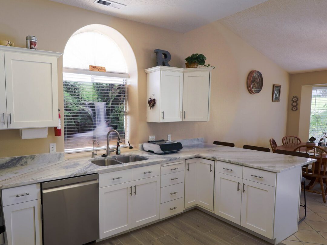 Open concept kitchen with a stone-topped peninsula opening to the dining area